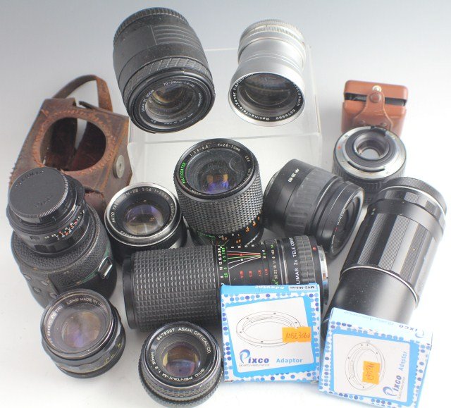 LOT OF CAMERA LENSES AND ACCESSORIES: LOT OF CAMERA LENSES AND ACCESSORIES Grouping of 10 lenses, 3 lens adaptors, a Tully Agfa flash, 35mm color film and 2 35mm black & white film unused. Compur Schneider - Kreuznach f 4/135mm, Super-Tak