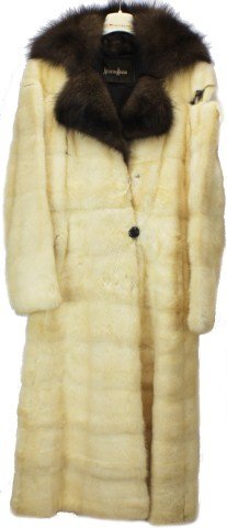 NEIMAN MARCUS VINTAGE WHITE FUR COAT: NEIMAN MARCUS VINTAGE WHITE FUR COAT White fur coat, in need of repair at the sleeves. Tag reads "Neiman Marcus". Coat is lined in brown and features brown collar, and brown buttons. Inside lining is 