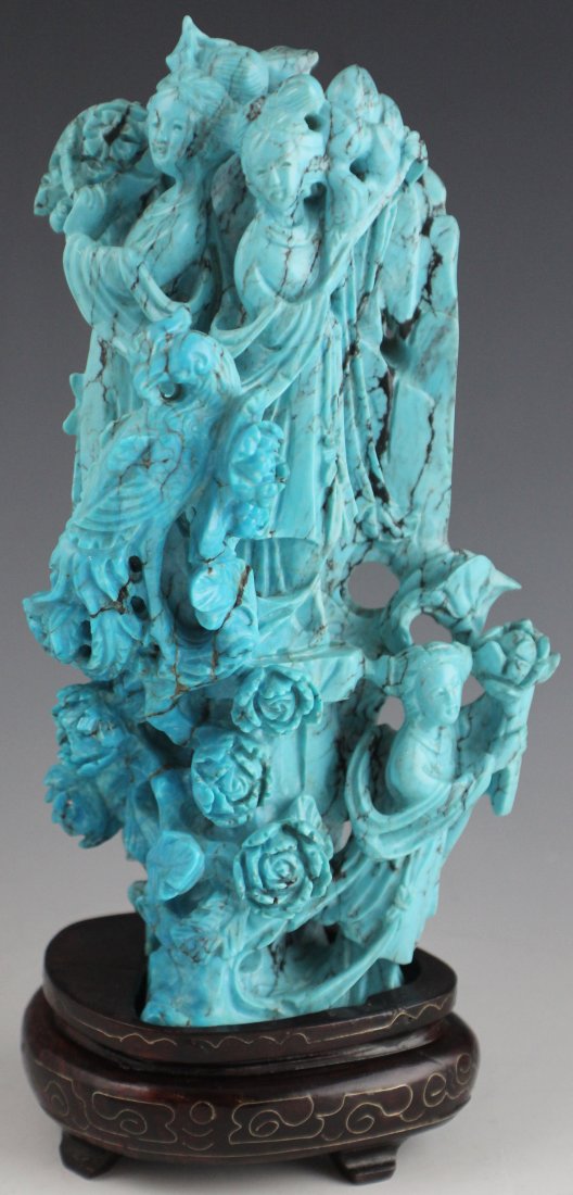 CHINESE CARVED TURQUOISE LADY GROUP SCENE: CHINESE CARVED TURQUOISE LADY GROUP SCENE A larger than usual ornately carved turquoise figural fantasy statue of three ladies amongst flowers and a bird of paradise. Presented on a silver inlaid wood
