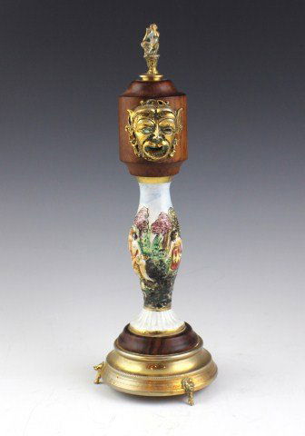 CAPODIMONTE REUGE MUSICAL BOX PEPPER GRINDER: CAPODIMONTE REUGE MUSICAL BOX PEPPER GRINDER Pepper grinder is constructed of a porcelain Capodimonte center, with wood and brass fittings above and below it. The Reuge Swiss Musical Movement is set i