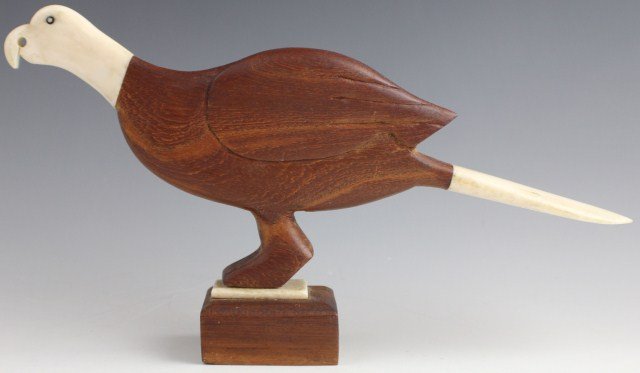 CARVED IVORY AND WOOD EAGLE: CARVED IVORY AND WOOD EAGLE Hand carved wooden bald eagle figure with ivory head and tail fittings. Set on wooden base. , Size: 5.5" tall, Est. 50-100, Lot 30380