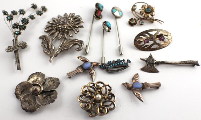 LARGE LOT OF STERLING PINS INCLUDING DANECRAFT: LARGE LOT OF STERLING PINS INCLUDING DANECRAFT Danecraft sterling floral pin; Bond Boyd sterling floral brooch; floral pin with blue rhinestones and bow; two matching sterling bird pins; one crown ste