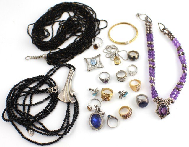 LARGE LOT OF LADIES STERLING FASHION JEWELRY: LARGE LOT OF LADIES STERLING FASHION JEWELRY Lot includes twelve rings with various stones; a necklace with teardrop yellow stone pendant; two pins with blue stones, one featuring a locket; once bangl