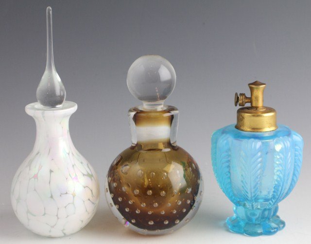 TWO VINTAGE GLASS PERFUME BOTTLES & AN ANTOMIZER: TWO VINTAGE GLASS PERFUME BOTTLES & AN ANTOMIZER Opalescent glass perfume bottle with dipper top. Brown based perfume with air inclusions, top with very slight damage. Pressed, blue glass atomizer, no