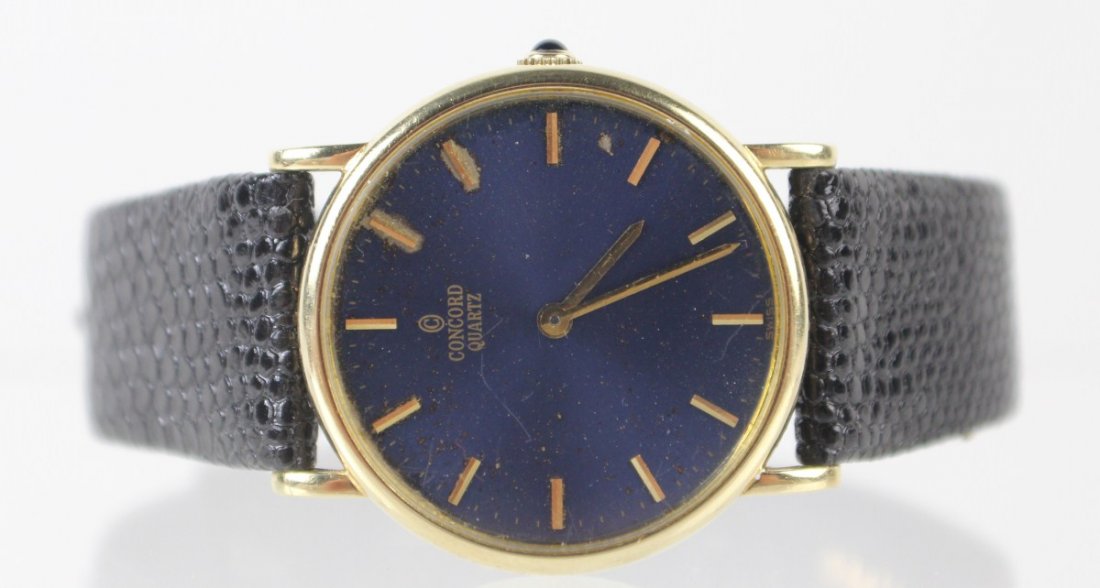 MENS CONCORD QUARTZ WATCH 14K CASE: MENS CONCORD QUARTZ WATCH 14K CASE Men's Concord Quartz watch, 2098217, 348747, blue face, gold five minute marks, tapered hands, no second hand, sapphire stem, leather band. Size: 30mm, Weight: 27.7g