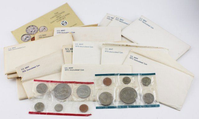 15 US MINT UNCIRCULATED COIN SETS D & P MARKS: 15 US MINT UNCIRCULATED COIN SETS D & P MARKS 1973 (2); 1975 (2); 1976 (2); 1977 (3); 1978 (2); 1979 (2); 1980; 1990. Each set includes penny, nickel, dime, quarter dollar, half dollar, and dollar coi
