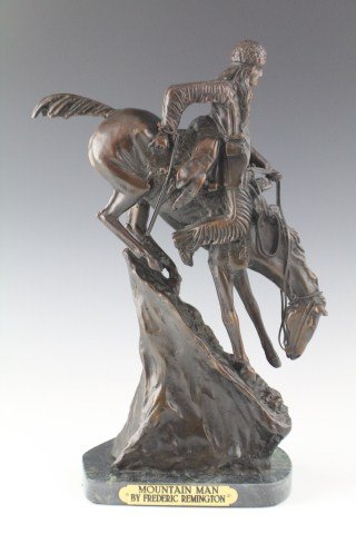 MOUNTAIN MAN - BRONZE STATUE FREDERIC REMINGTON: MOUNTAIN MAN - BRONZE STATUE FREDERIC REMINGTON Signed cold cast bronze statue by Frederic Remington. Features a man and his beast descending the treacherous mountain landscape. Size: 13 3/4" tall inc