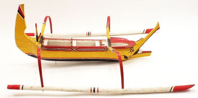 BALINESE TRIMARAN MODEL OF A NATIVE CANOE: BALINESE TRIMARAN MODEL OF A NATIVE CANOE 3ft long yellow, wooden, Trimaran canoe model. This Balinese boat model was made and signed by Ida Bagus Rai Sidemen and Br. Buruwan in Denpasar, Bali, Indone