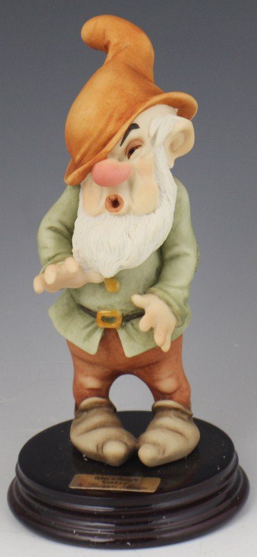 ARMANI PORCELAIN FIGURE SNEEZY - WALT DISNEY 0914C: ARMANI PORCELAIN FIGURE SNEEZY - WALT DISNEY 0914C Walt Disney's "Sneezy" from Snow White and the Seven Dwarfs by Giuseppe Armani. Porcelain figurine on wooden base, hand signed by Guiseppe Armani. Ma
