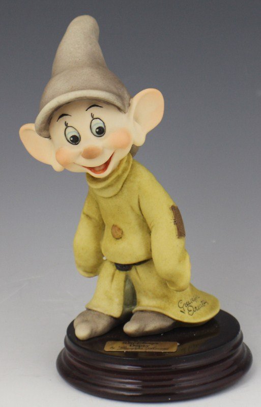 ARMANI PORCELAIN FIGURE DOPEY - WALT DISNEY 0200C: ARMANI PORCELAIN FIGURE DOPEY - WALT DISNEY 0200C Walt Disney's "Dopey" from Snow White and the Seven Dwarfs by Giuseppe Armani. Porcelain figurine on wooden base. Made in Italy. Size: 6.25" (with bas