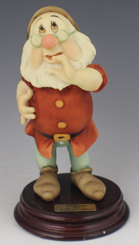 ARMANI PORCELAIN FIGURE DOC - WALT DISNEY 0326C: ARMANI PORCELAIN FIGURE DOC - WALT DISNEY 0326C Walt Disney's "Doc" from Snow White and the Seven Dwarfs by Giuseppe Armani. Porcelain figurine on wooden base, hand signed by Guiseppe Armani. Made in 
