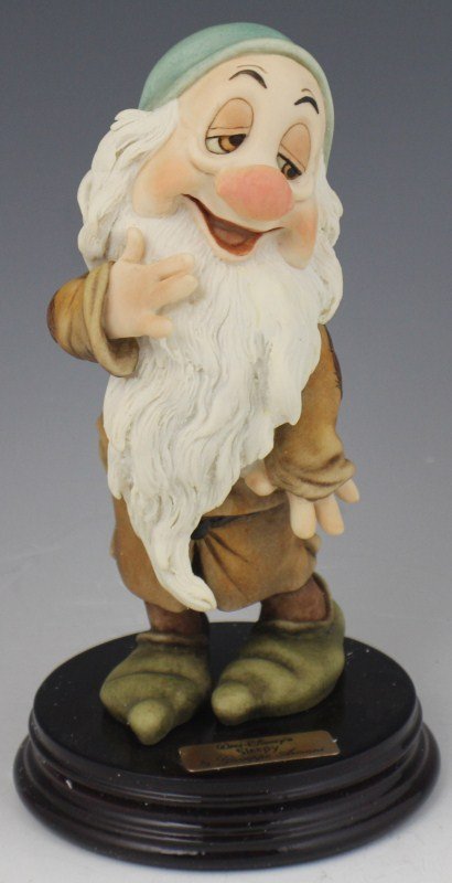 ARMANI PORCELAIN FIGURE SLEEPY - WALT DISNEY 0915C: ARMANI PORCELAIN FIGURE SLEEPY - WALT DISNEY 0915C Walt Disney's "Sleepy" from Snow White and the Seven Dwarfs by Giuseppe Armani. Porcelain figurine on wooden base, hand signed by Guiseppe Armani. Ma