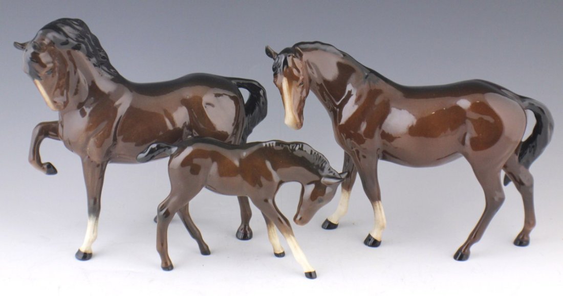 LOT OF THREE ROYAL DOULTON HORSE FIGURES: LOT OF THREE ROYAL DOULTON HORSE FIGURES Lot of Three Royal Doulton Horse Figures. Large Stallion with raised hoof measures 8 x 8". Large Mare looking to the left, measures 9 x 7". Small Foal stretche