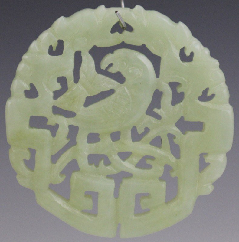CHINESE CARVED JADE DISC FEATURING BIRD: CHINESE CARVED JADE DISC FEATURING BIRD A Chinese carved jade disc, featuring a bird. Size: 56mm Est. $ 50-150 Lot 31275