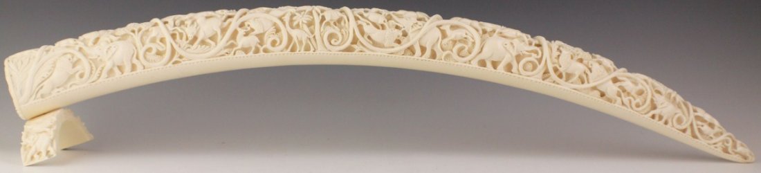 AFRICAN CARVED JUNGLE SCENE ELEPHANT IVORY TUSK: AFRICAN CARVED JUNGLE SCENE ELEPHANT IVORY TUSK A very well carved elephant ivory tusk with ornate and intricately carved animals such as elephant, lion, deer, giraffe and more. The open end is capped