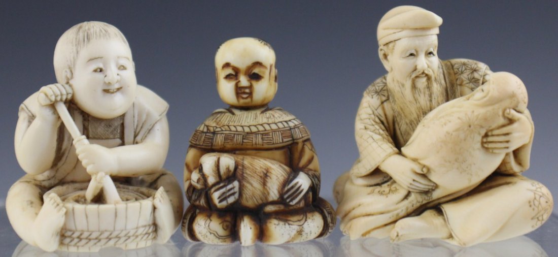 LOT OF THREE CARVED IVORY JAPANESE NETSUKES: LOT OF THREE CARVED IVORY JAPANESE NETSUKES Lot of three carved ivory Japanese netsukes. One features a seated man with a dog in his lap, one is a seated girl stirring a pot, and a seated male figure 
