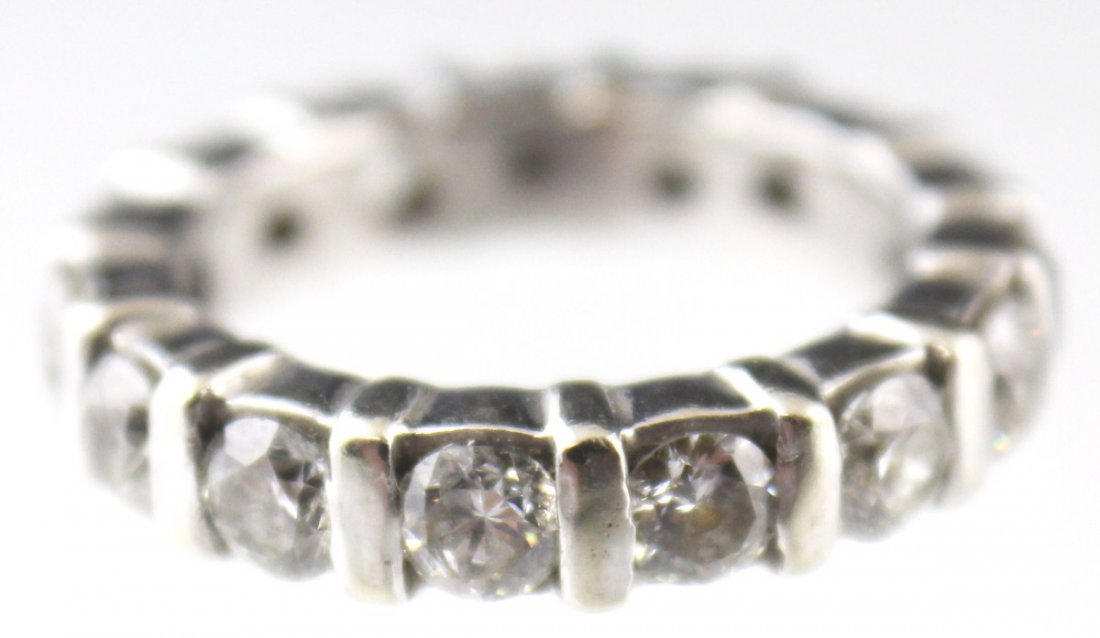 LADIES 14K WHITE GOLD DIAMOND WEDDING BAND: LADIES 14K WHITE GOLD DIAMOND WEDDING BAND 14K white gold eternity diamond wedding band. 15 round cut diamonds of 0.15 ct each for approximately 2.25 Ctw. Weight: 5.8g Size: 5.25 Est. $ 400-600 Lot 31