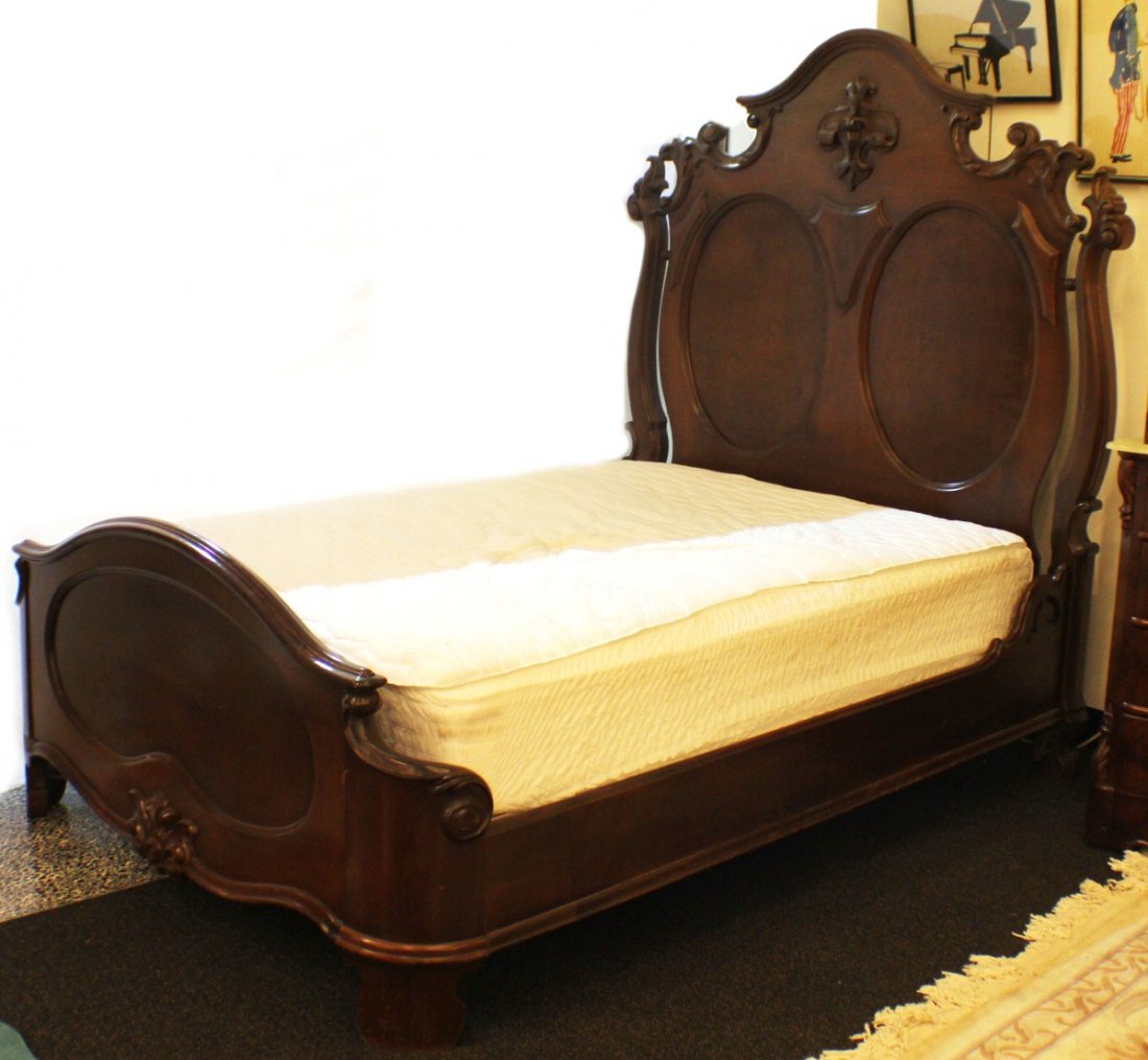 MAHOGANY RENAISSANCE REVIVAL QUEEN BED: MAHOGANY RENAISSANCE REVIVAL QUEEN BED mahogany Renaissance Revival style queen size bed with tall ornate headboard, side rails, and lot ornate footboard. Headboard has exaggerated c scroll top shape,