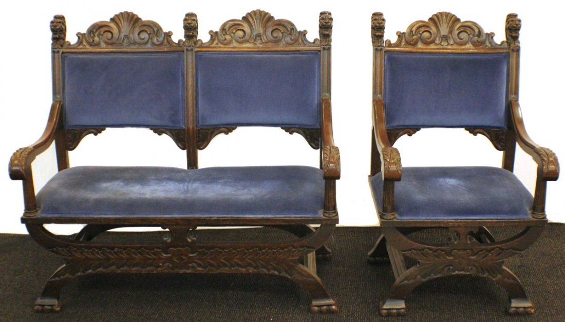 HAND CARVED LION'S HEAD MATCHING SETTEE AND CHAIR: HAND CARVED LION'S HEAD MATCHING SETTEE AND CHAIR Hand carved settee and matching chair, both upholstered in blue velvet fabric and feature lion head carvings. Settee seats two, and measures 42 x 45 x