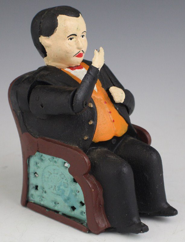CAST IRON TAMMANY MECHANICAL BANK: CAST IRON TAMMANY MECHANICAL BANK Black pants, J & E Stevens Co., designed by John D. Hall, patented 12/23/1873. Put a coin in his hand, and see how promptly he pockets it, and how politely he bows hi
