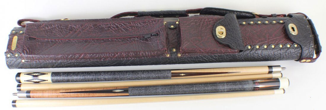 2 JOSS POOL CUES IN LEATHER CASE: 2 JOSS POOL CUES IN LEATHER CASE Two Joss two piece pool cues. "Joss" wood inlay with black and white linen wrap. "Joss Cues" with mother of pearl and wood inlay with black and white linen wrap. Cues