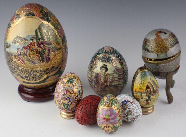 LOT OF EIGHT VARIOUS CHINESE EGGS: LOT OF EIGHT VARIOUS CHINESE EGGS Three painted porcelain eggs, three cloisonne eggs, one cinnabar egg, and one enameled. Some with stands. Size: 3-5" Est. $75-150 Lot: 33051