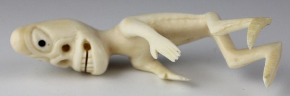 GREENLAND INUIT TUPILAK CARVED IVORY SPIRIT FIGURE: GREENLAND INUIT TUPILAK CARVED IVORY SPIRIT FIGURE A native Inuit Tupilak spirit figure carved from whale's tooth. Does not stand up. Size: 3.5" Est. $100-200 Lot: 33076
