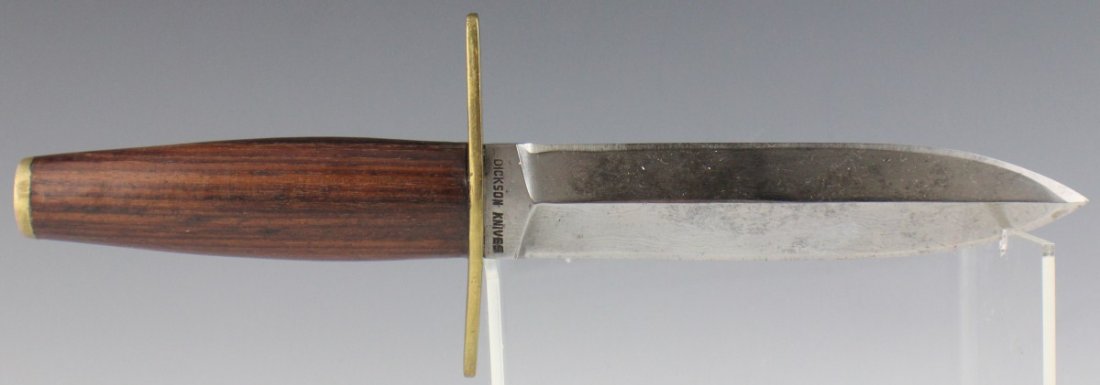 DICKSON HAND MADE DAMASCUS BLADE BOWIE KNIFE: DICKSON HAND MADE DAMASCUS BLADE BOWIE KNIFE Double edged custom Damascus steel knife. Made by Dickson Knives GA. Brass cross guard with wooden handle that tapers to a brass pommel cap. Blade is 6" in