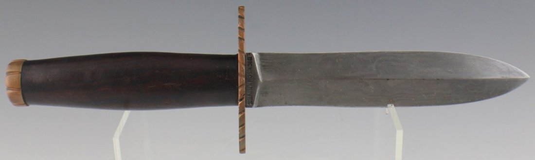 DICKSON HAND MADE DAMASCUS BLADE BOWIE KNIFE: DICKSON HAND MADE DAMASCUS BLADE BOWIE KNIFE Double edged custom Damascus steel knife. Made by Dickson Knives GA. copper cross guard with wooden handle that tapers to a copper pommel cap. Blade is 6" 