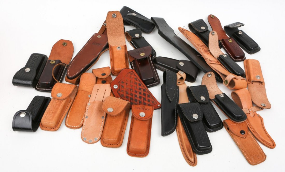 MIXED LOT OF 30 KNIFE SHEATHS ALL LEATHER: MIXED LOT OF 30 KNIFE SHEATHS ALL LEATHER A dealers lot of 30 leather sheaths of different shapes and sizes. Includes folding knives. Some may be named. Please see pictures before bidding. Size: vario
