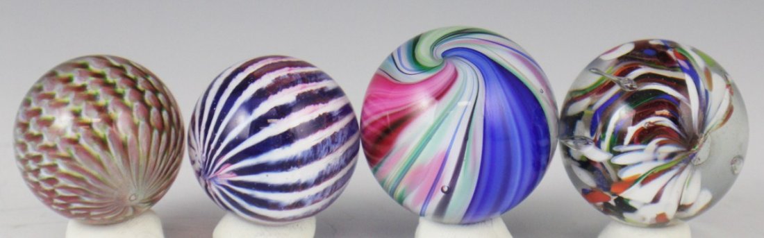 LOT OF FOUR RAINBOW SWIRL PEACOCK & ONIONS MARBLES: LOT OF FOUR RAINBOW SWIRL PEACOCK & ONIONS MARBLES Lot of four handmade glass marbles 37.5mm to 42mm. Est. $20-40 Lot: 33318