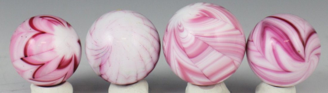 LOT OF FOUR PINK SNAKESKIN AND SWIRL MARBLES: LOT OF FOUR PINK SNAKESKIN AND SWIRL MARBLES Lot of 4 handmade glass pink marbles 36.5mm to 42.5mm. Est. $20-40 Lot: 33319