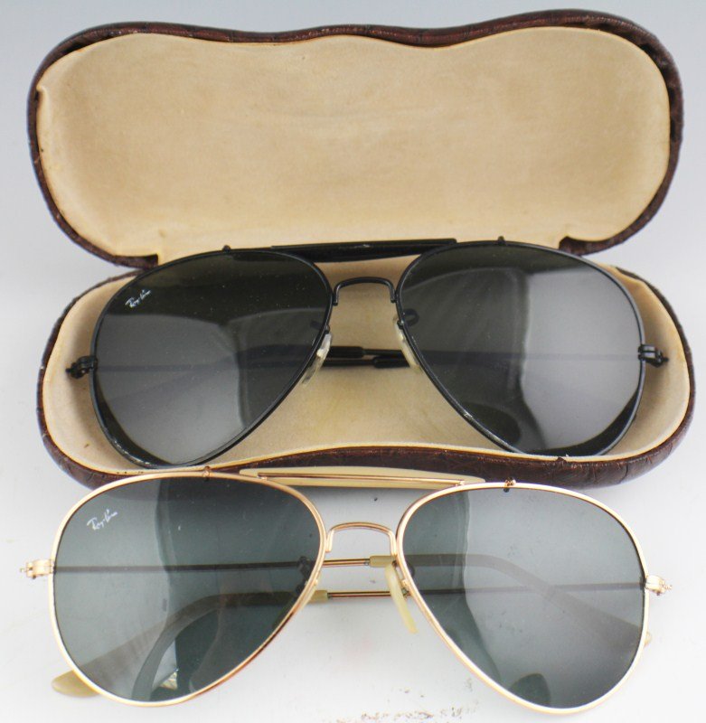 2 VINTAGE RAY BAN SUNGLASSES: 2 Vintage Ray Ban sunglasses one with a gold frame the other is black framed. Comes with one brown leather case as well. Est$50-100