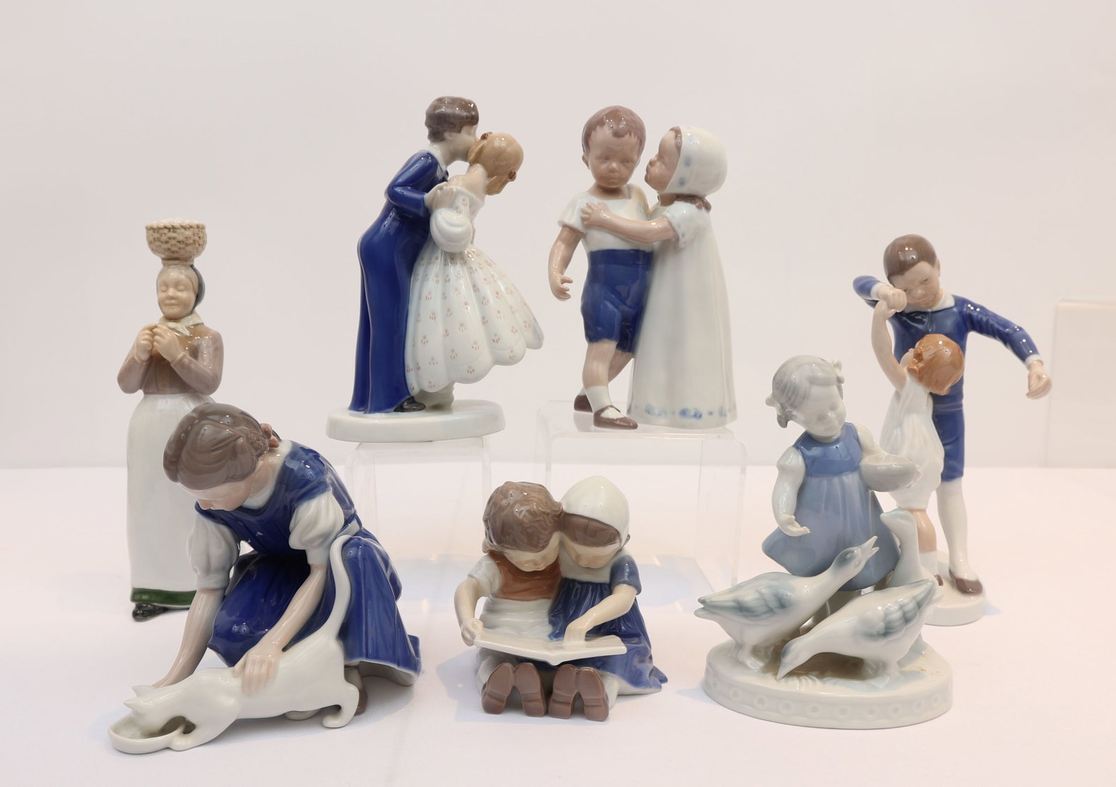 BING & GRONDEL LOT OF 6, 1 GERALD PORZELLAN: Bing and Grondel - Dancing School- 2 children dancing, Girl feeding cat, Young couple kissing, Children hugging, Children sitting and reading a book together, Woman with egg basket on head. Gerold Por