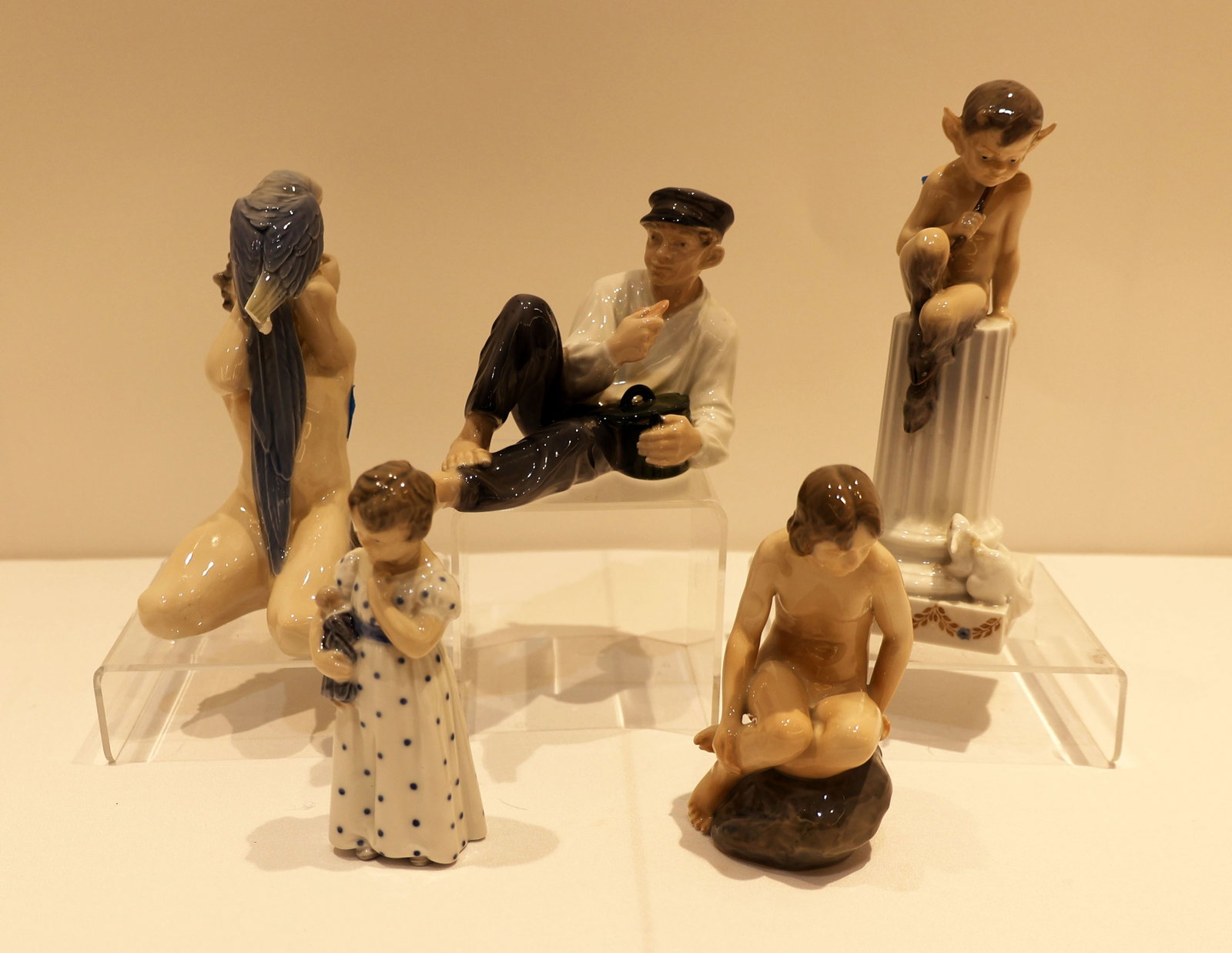 ROYAL COPENHAGEN FIGURINES LOT OF 5: Royal Copenhagen Shepherd boy eating lunch, Nude girl on stone, Girl with doll on her arm, Fawn with parrot (damage to tail), Faun figurine with rabbit (damage to rabbit ear) Any damage has been noted