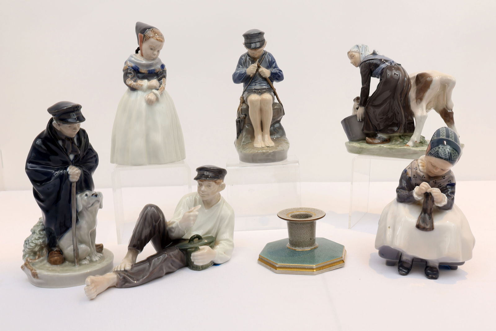 ROYAL COPENHAGEN LOT OF 6 FIGURINES & CANDLESTICK: A manger Girl Standing1251, Boy whittling a stick, Shepherd boy with dog, Reclining boy eating lunch, A manger girl sitting knitting 1314- small imperfection in casting, girl feeding calf from a bucke