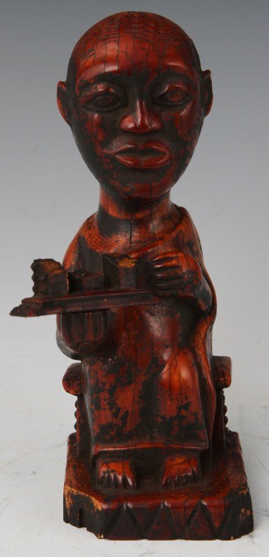 19TH C AFRICAN CARVED IVORY MEDICINE FIGURE: 19TH C AFRICAN CARVED IVORY MEDICINE FIGURE An African carved ivory figure, most likely used in the pursuit of medicinal or religious practices. Depicted as a seated and robed male holding a tray with