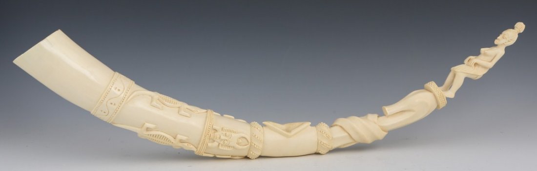 AFRICAN CARVED IVORY TUSK IN THE FORM OF A TOTEM: AFRICAN CARVED IVORY TUSK IN THE FORM OF A TOTEM African carved ivory tusk in the form of an ancestral totem. Carved lizard figures and the faces of ancestors. Topped by a full figural ancestral carvi