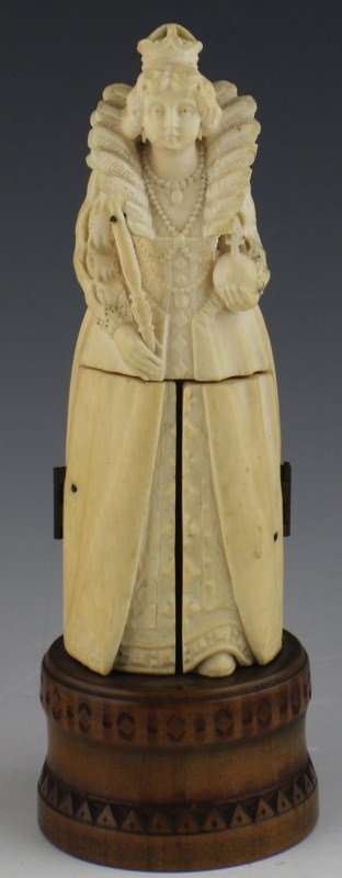 EUROPEAN CARVED IVORY TRIPTYCH FIGURE ELIZABETH I: EUROPEAN CARVED IVORY TRIPTYCH FIGURE ELIZABETH I A very finely carved elephant ivory figure of Elizabeth I. The skirt opens to show courtiers. A fixed to a light wood stand. Size: 7" total height