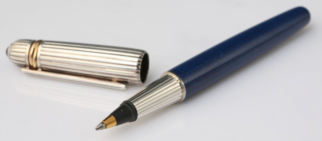 PASHA DE CARTIER TRINITY BALLPOINT PEN: PASHA DE CARTIER TRINITY BALLPOINT PEN Pasha de Cartier Trinity roller ball pen having a blue lacquered body and cabochon spinel atop the pen cap. Marked 1989 2890. Size: 5.75"