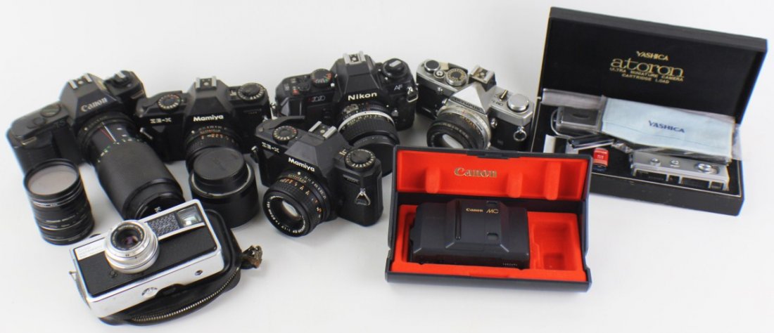 8 CAMERAS 7 LENS AND 14 LENS COVERS: 8 CAMERAS 7 LENS AND 14 LENS COVERS Grouping of cameras and accessories to include; Kodak Instamatic 500 with Xenar f 2.8, Olympus OM-1 with Olympus 50mm, (2) Mamiya ZE-X with Sekor EF 50mm, Canon T-5