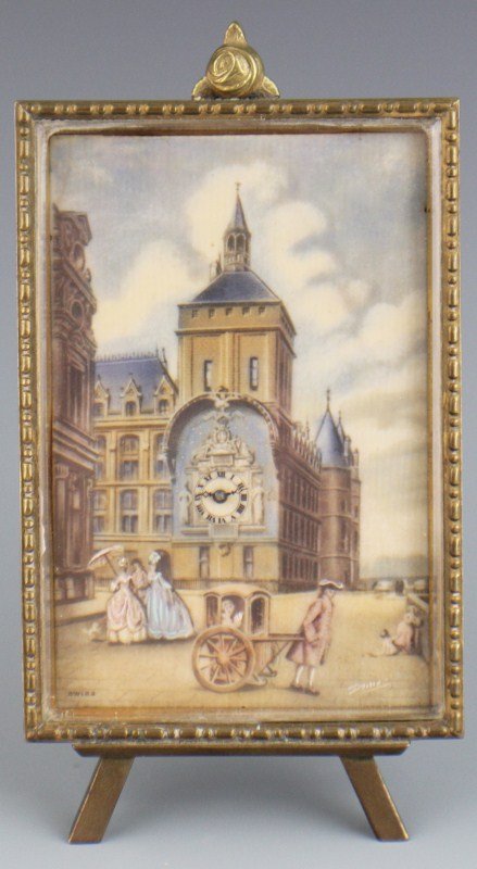 SWISS HANDPAINTED IVORY PANEL DESK CLOCK: A Fab Suisse desk clock set within a gilt frame. Hand painted ivory panel depicts a renaissance urban scene, swiss movement clock cleverly integrated into the tower. Vibrant blue, pink and white accen