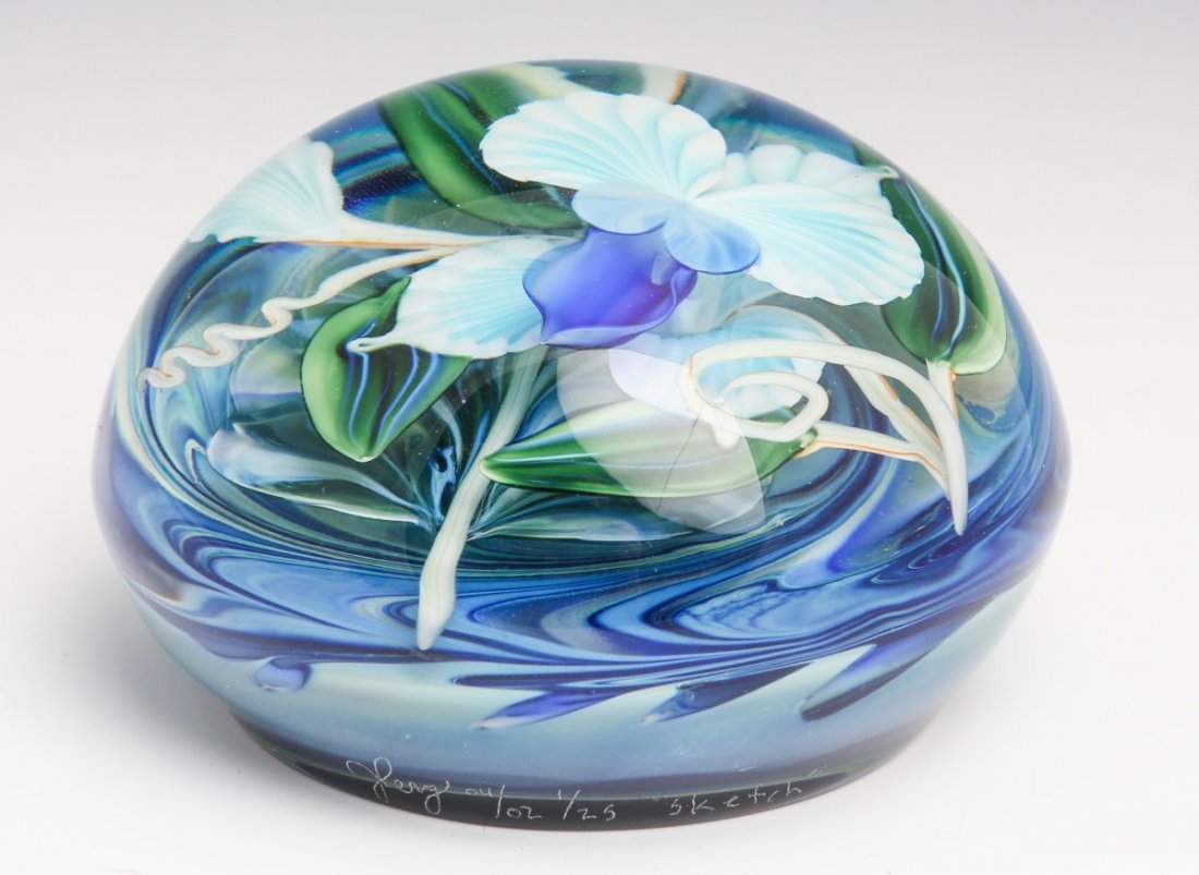 JUSTIN LUNDBERG ART GLASS PAPERWEIGHT SIGNED 1/25: JUSTIN LUNDBERG ART GLASS PAPERWEIGHT SIGNED 1/25 Number 1 of limited edition. Floral design. Blue background with multicolor flowers. Signed : (Justin Lundberg signature) 4/02 1/25 "sketch". Foil lab