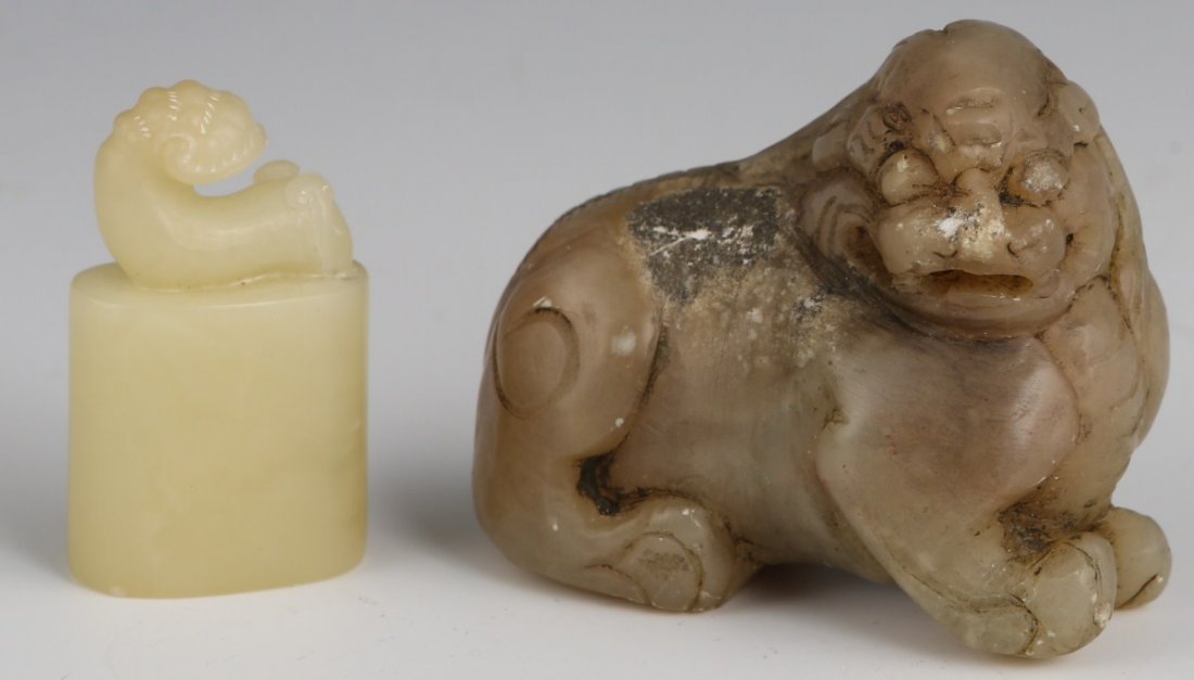 TWO SOAPSTONE CARVINGS FOO DOG AND SEAL: TWO SOAPSTONE CARVINGS FOO DOG AND SEAL Two small soap stone carvings one small food dog with minor erosion and the other creamy seal stone. Size: 1.5 & 1.75