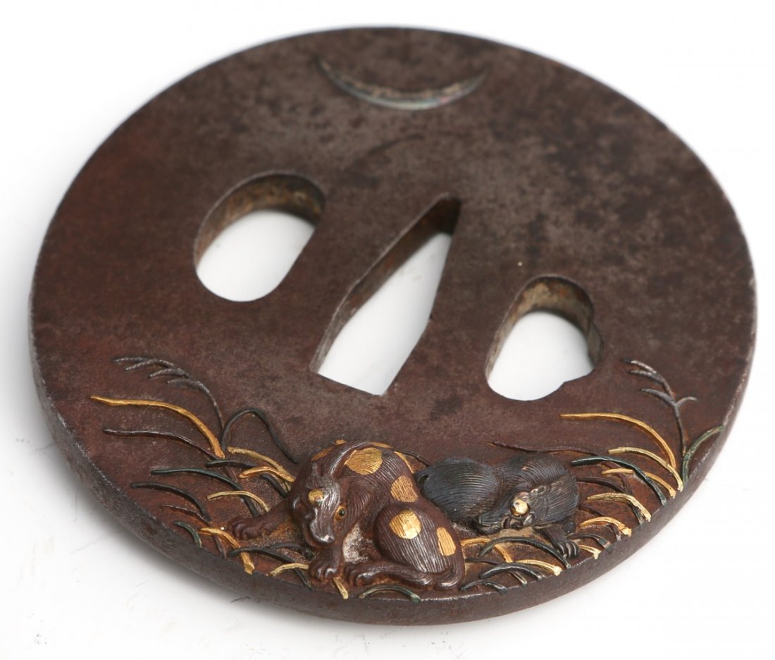A GILDED & SILVERED CAST IRON JAPANESE SWORD TSUBA: A GILDED & SILVERED CAST IRON JAPANESE SWORD TSUBA Japanese sword guard (tsuba) in cast iron with silver and gilt decoration. Unsigned. Size: 2.75"