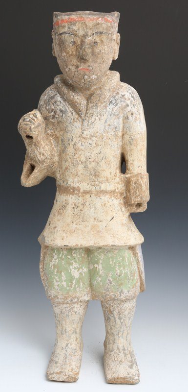 HAN DYNASTY CHINESE TERRACOTTA GUARDIAN SCULPTURE: HAN DYNASTY CHINESE TERRACOTTA GUARDIAN SCULPTURE 207BC - 9AD Han Dynasty figure in terracotta with painted clothes and features. Size: 20" tall