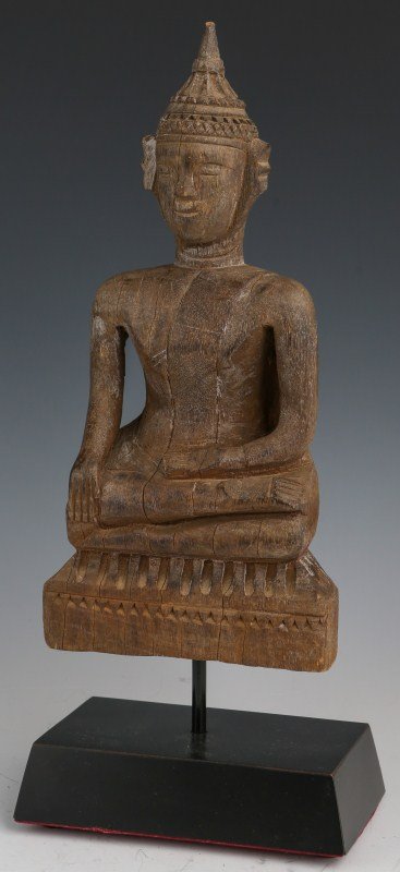 NEPALESE SHRINE OR TEMPLE WOOD DEITY FIGURE: NEPALESE SHRINE OR TEMPLE WOOD DEITY FIGURE A Nepalese temple Buddha figure. Carved wood, 19th Century. Raised, on a wood stand. Size: 13" including the stand