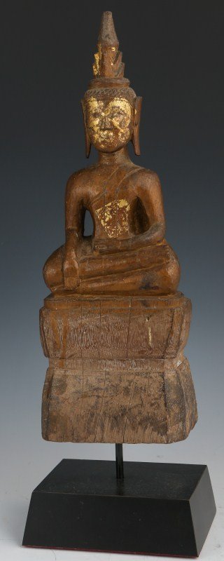 NEPALESE SHRINE OR TEMPLE WOOD DEITY FIGURE: NEPALESE SHRINE OR TEMPLE WOOD DEITY FIGURE A Nepalese temple Buddha figure. Carved wood, 19th Century. Raised, on a wood stand. Some gilding remains. Size: 16.5" including the stand