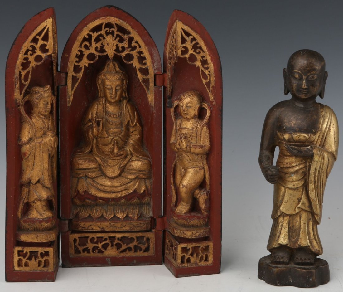 SOUTHEAST ASIAN BUDDHA FIGURES: SOUTHEAST ASIAN BUDDHA FIGURES Two south east Asian Buddha figures. A wooden cylinder hinged to reveal three carved figures within, painted in garnet and gilt. Center figure is a seated Buddha, accomp