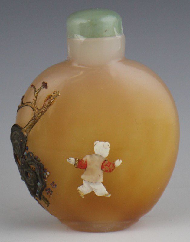 LATE 18th or 19th CHINESE GLASS SNUFF BOTTLE: LATE CHINESE GLASS SNUFF BOTTLE Late 18th early 19th century peach glass snuff bottle with soapstone child and bird applied detail. Hand painted accents separate this from others of that period, with 